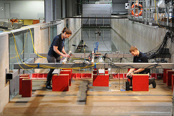 Photo of two people working on the tsunami simulator