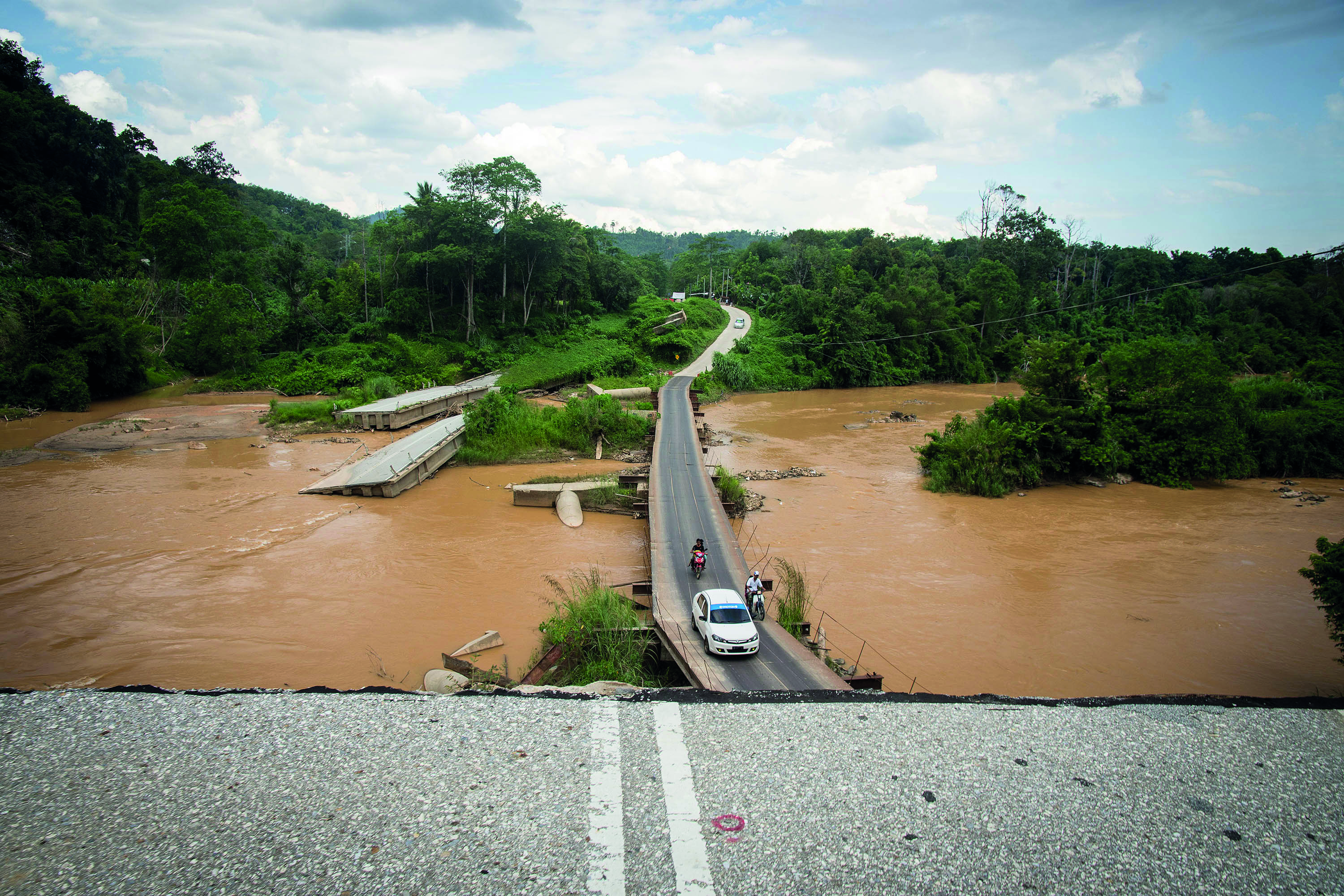 View of a bridge destroyed by flooding in Eastern Malaysia