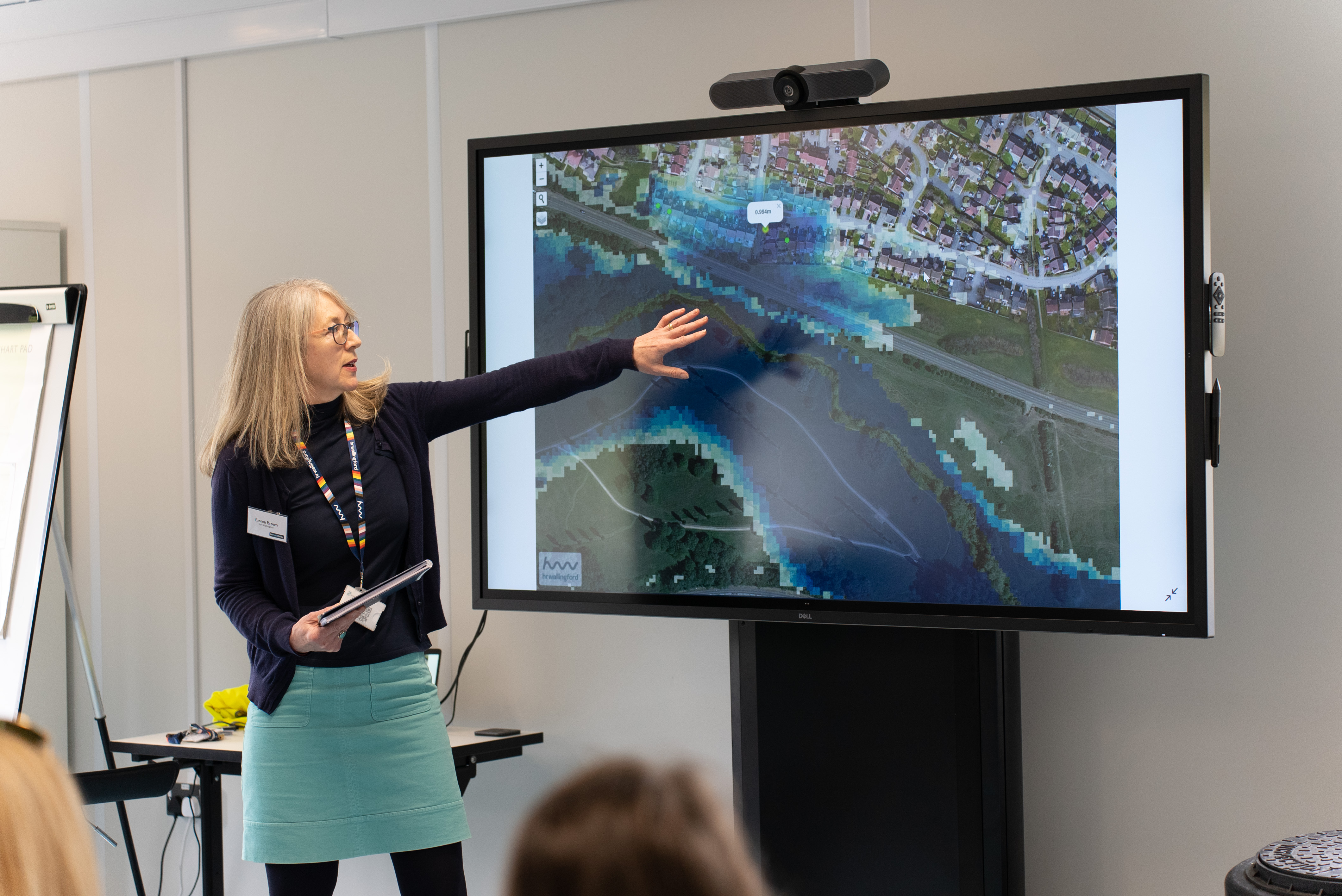 Emma Brown presenting in front of screen