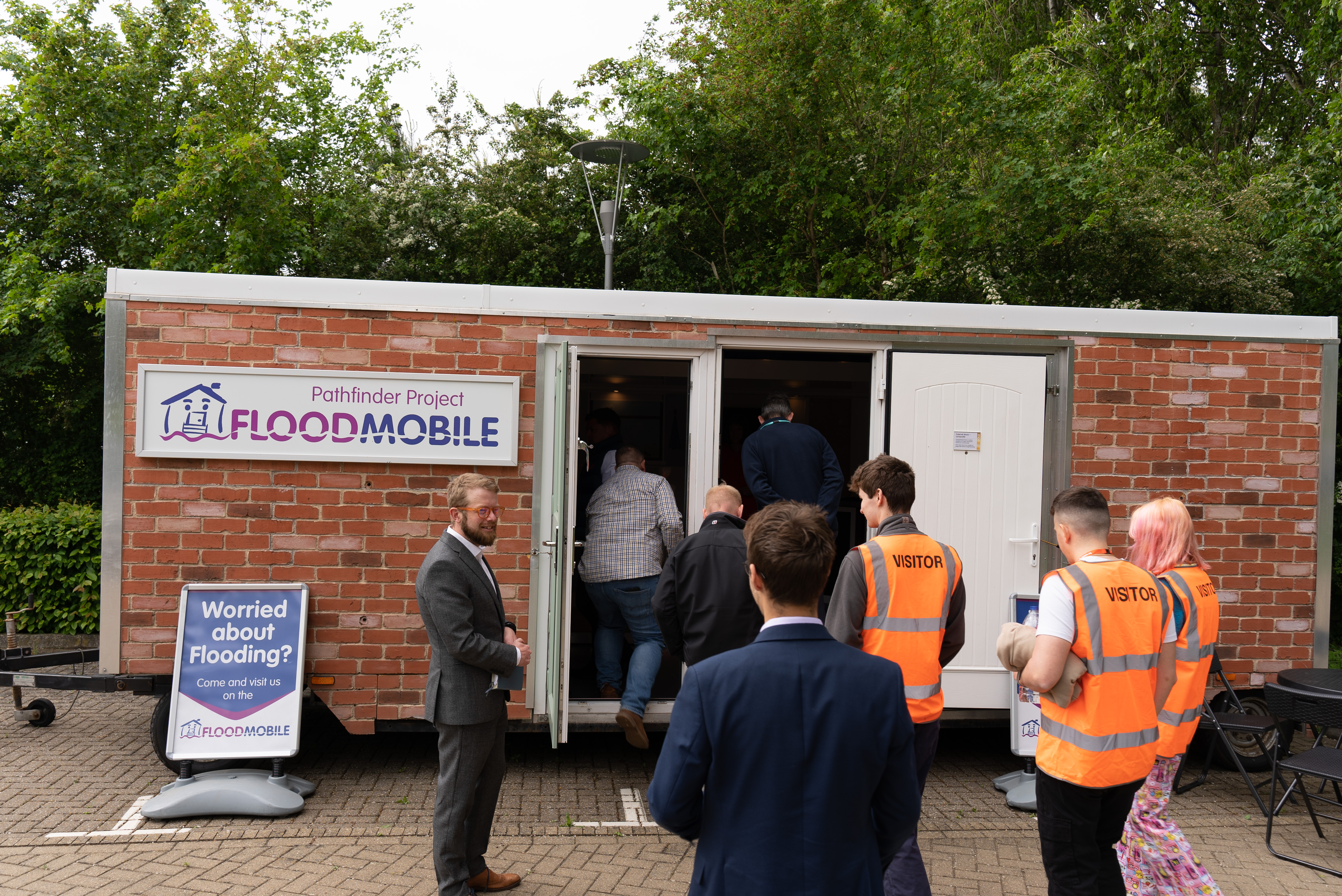 Group of people waiting to enter the BE Flood Smart building at Howbery Park
