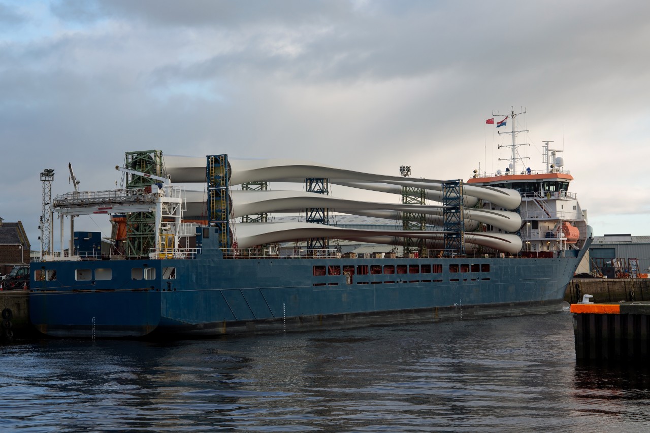 Ship with wind turbines moored at a port