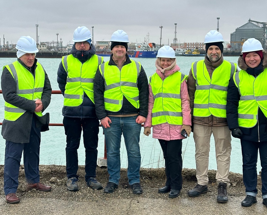 HR Wallingford and World Bank staff in high visibility jackets standing for a picture in Port of Aktau on Caspian sea