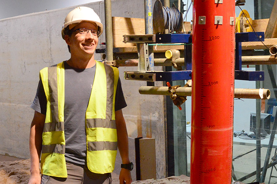 Russell Mayall, Oxford University DEng student, with the monopile test equipment in the Fast Flow Facility at HR Wallingford