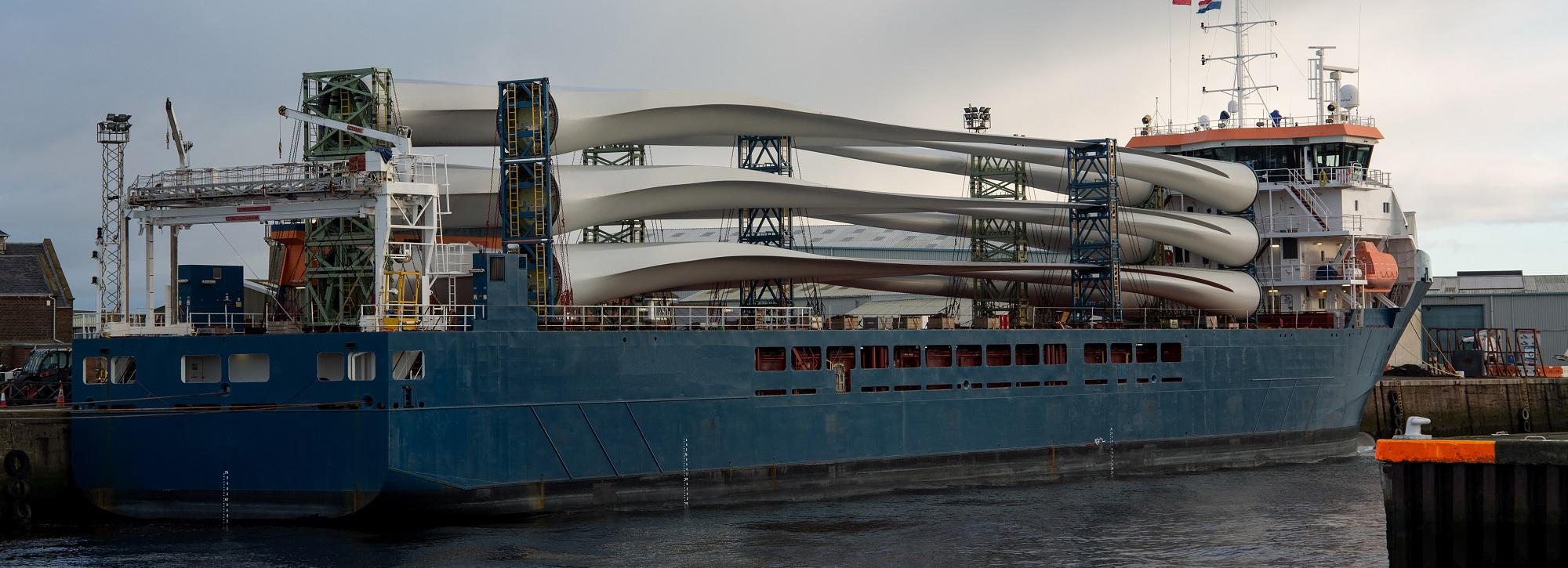 Ship loaded with wind turbines moored at a port