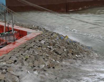 Close-up of wave on breakwaters in physical model