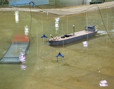 Photo of physical model of Oosterweel Scheldt tunnel with a model boat