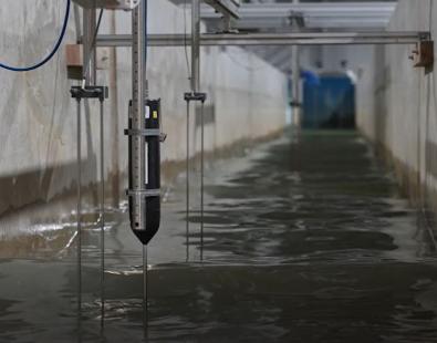 view of a flume physical model with water and instrumentation
