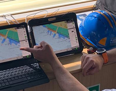 View of a pilot in front of two computer screens