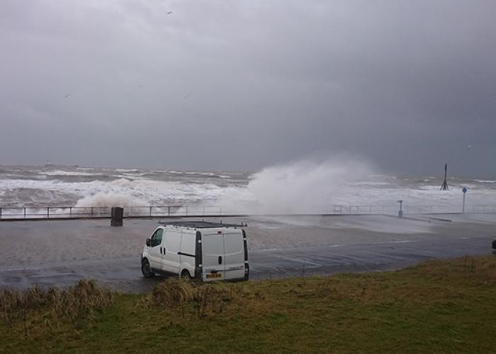 View of van on beach behind seawall