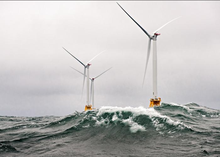 View of two wind turbines in turbulent sea