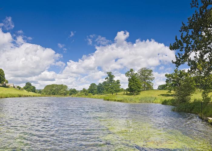 View of wide freshwater river with green river banks