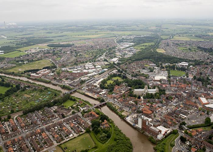 Aerial view of a catchment with river, bridge, houses