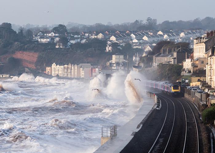 Wave overtopping coasts causing floods on railway tracks