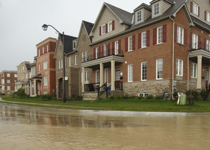New houses development surrounded by brown water due to flooding