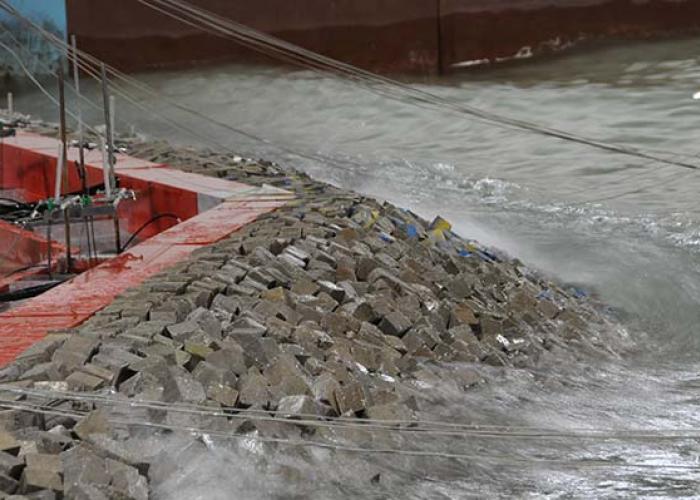 Close-up of wave on breakwaters in physical model