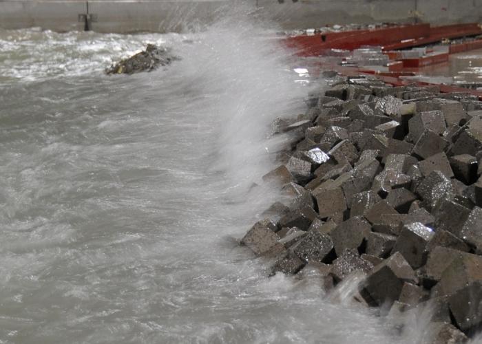 View of waves crashing on modelled breakwater 