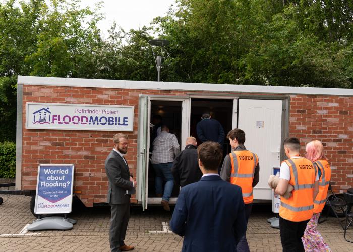 Group of people waiting to enter the BE Flood Smart building at Howbery Park