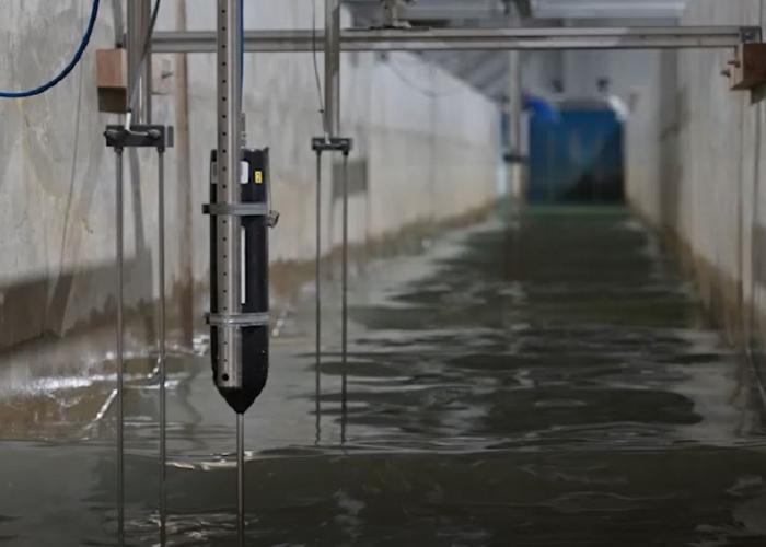 View of a flume physical model with water and instrumentation