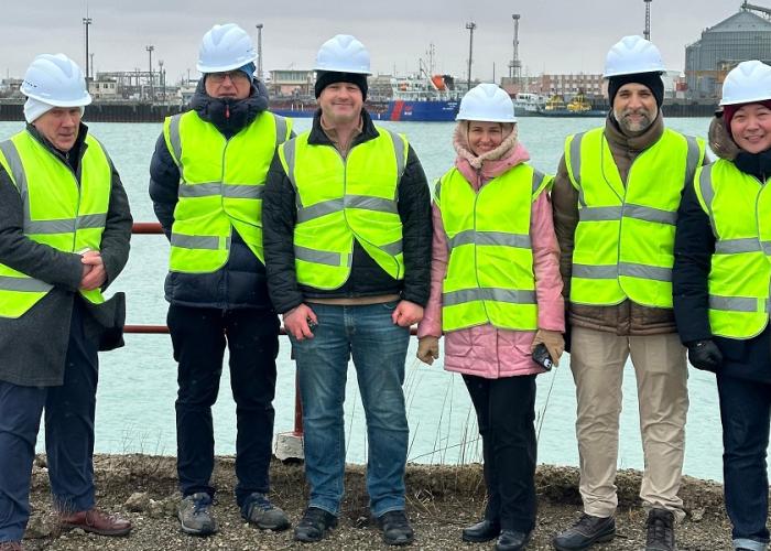 HR Wallingford and World Bank staff in high visibility jackets standing for a picture in Port of Aktau on Caspian sea