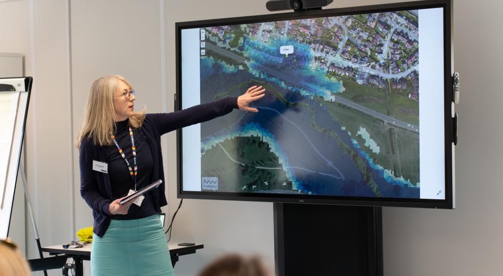 Emma Brown presenting in front of screen