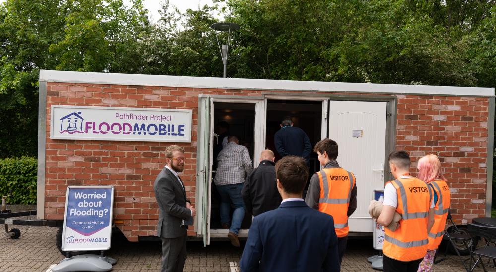 Group of people waiting to enter the BE Flood Smart building at Howbery Park