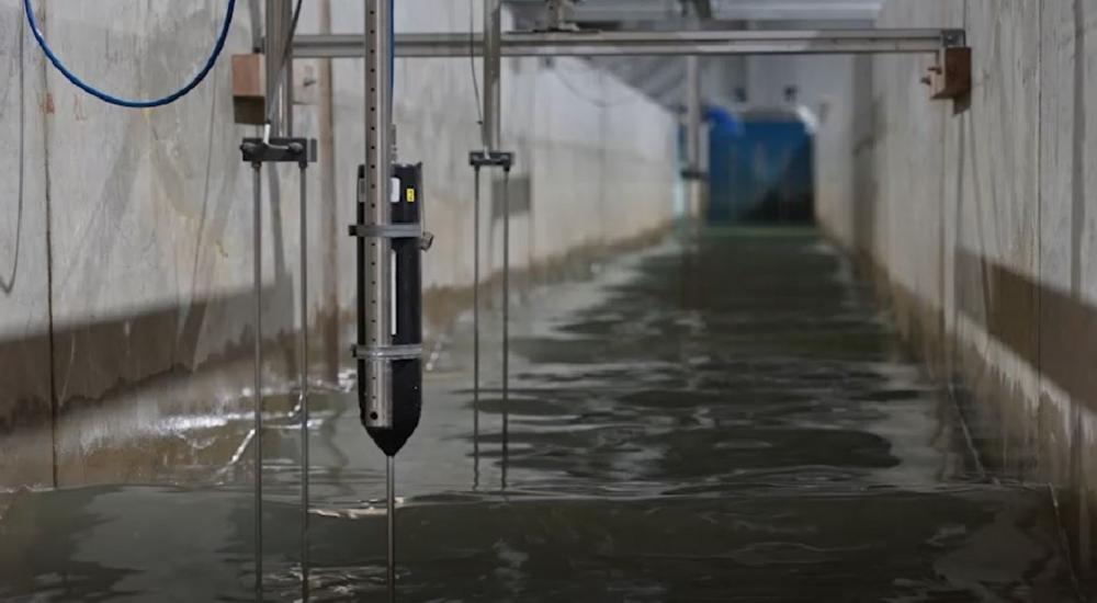 View of a flume physical model with water and instrumentation