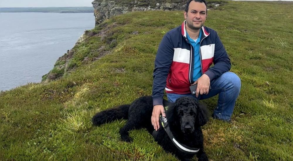 CFD expert, Sina Haeri on a walk on a cliff by the sea with his dog