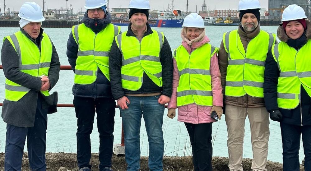 HR Wallingford and World Bank staff in high visibility jackets standing for a picture in Port of Aktau on Caspian sea