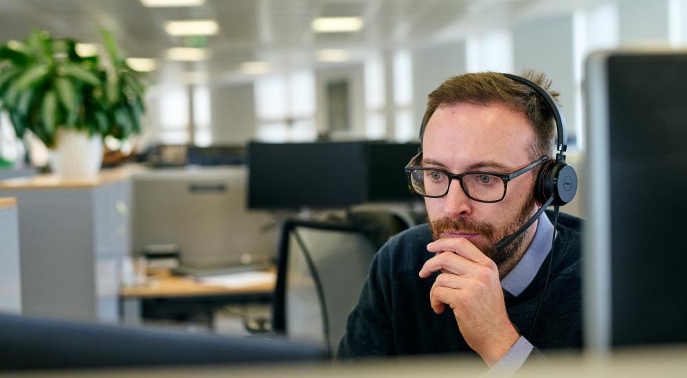 Scientist Connor McCarron sitting at his desk