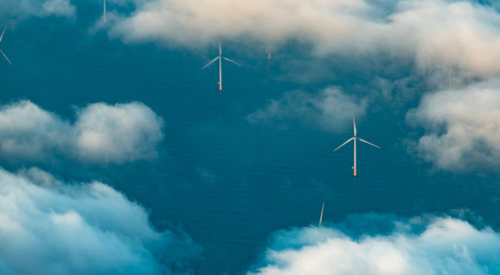 Aerial view of wind farm in sea with white clouds