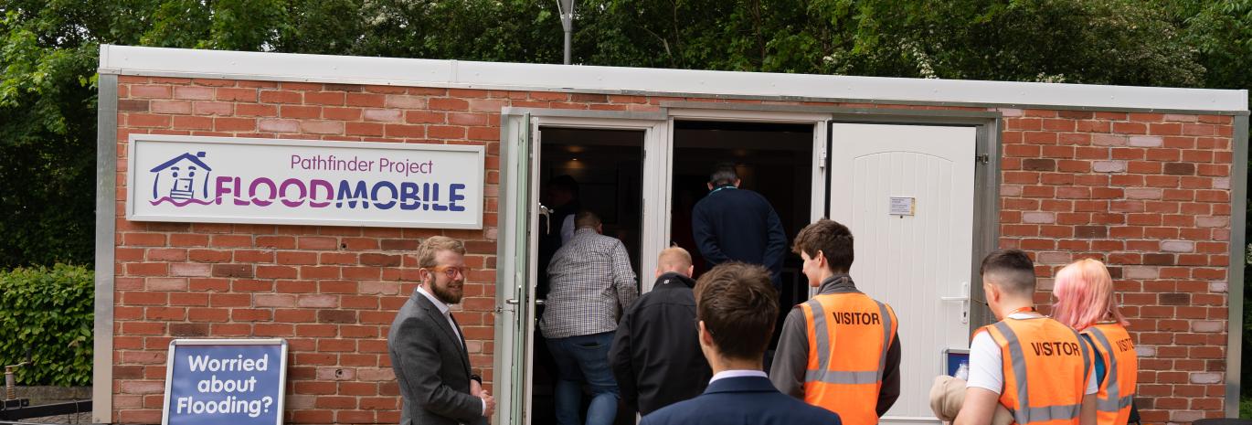 Group of people waiting to enter the BE Flood Smart building at Howbery Park