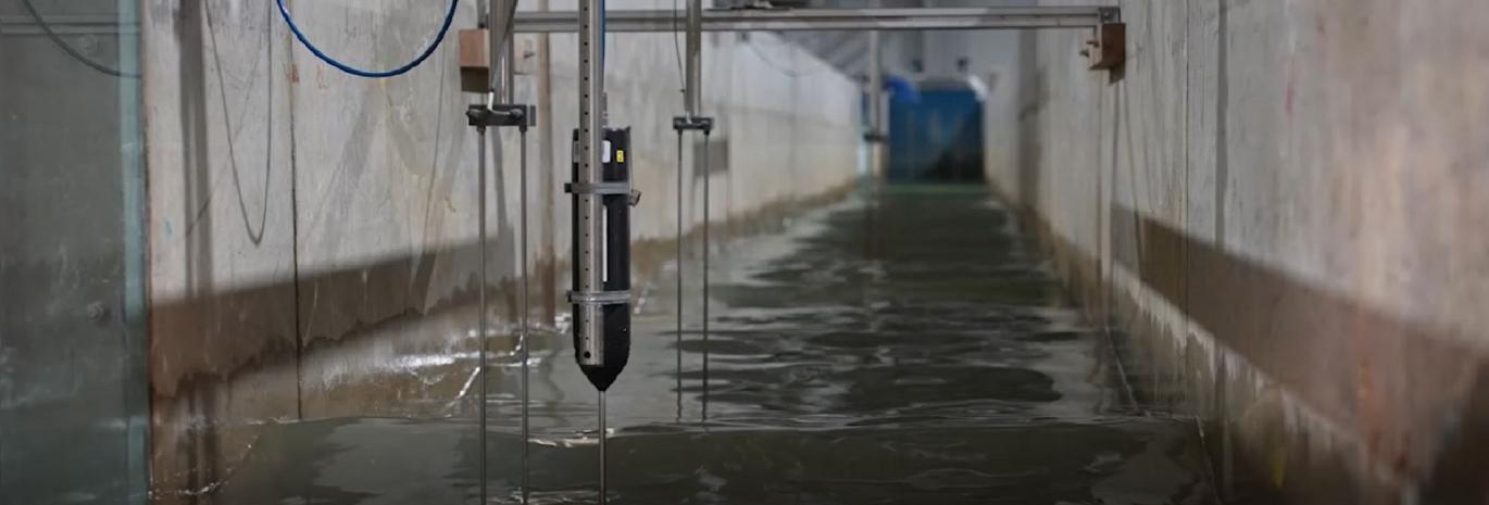 View of a flume physical model with water and instrumentation