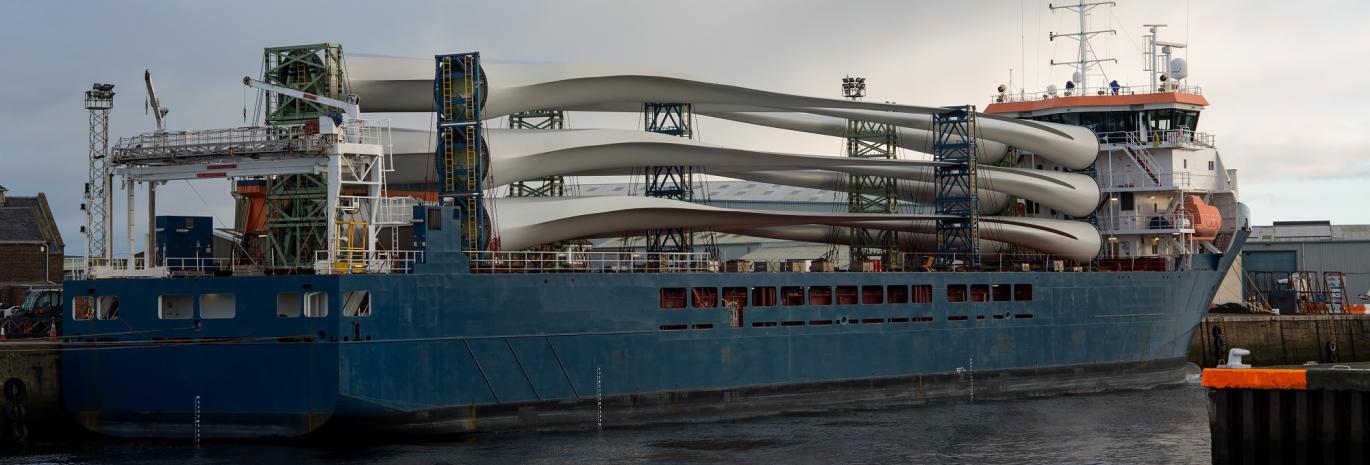 Ship loaded with wind turbines moored at a port