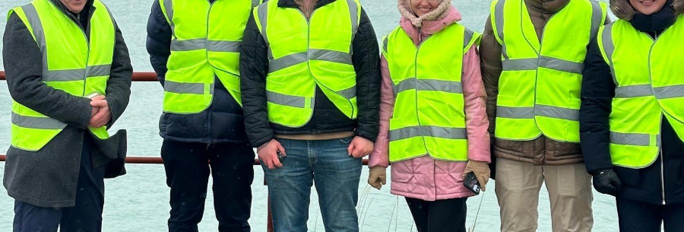HR Wallingford and World Bank staff in high visibility jackets standing for a picture in Port of Aktau on Caspian sea