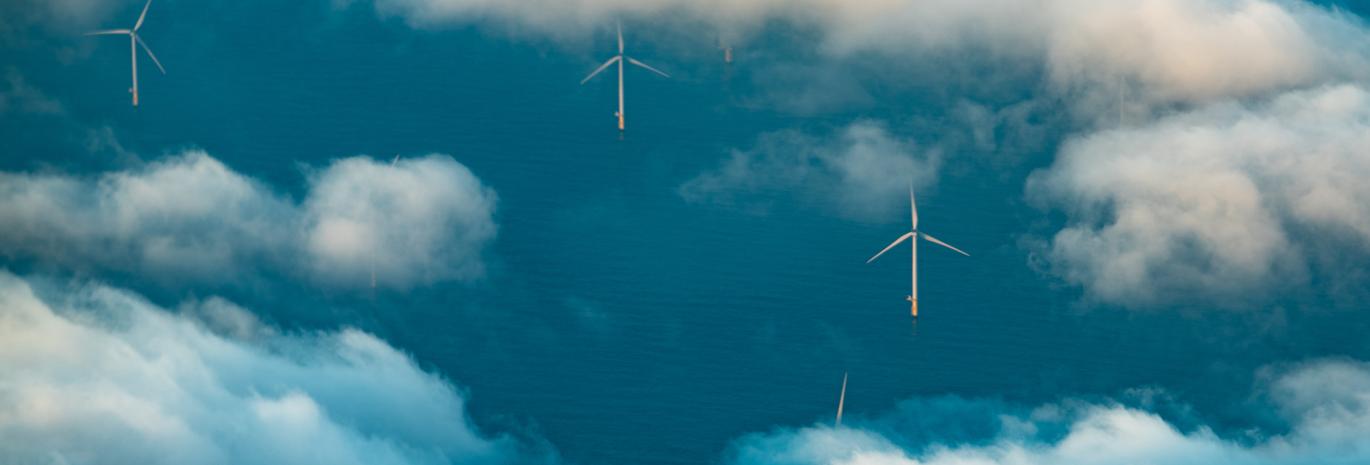 Aerial view of wind farm in sea with white clouds