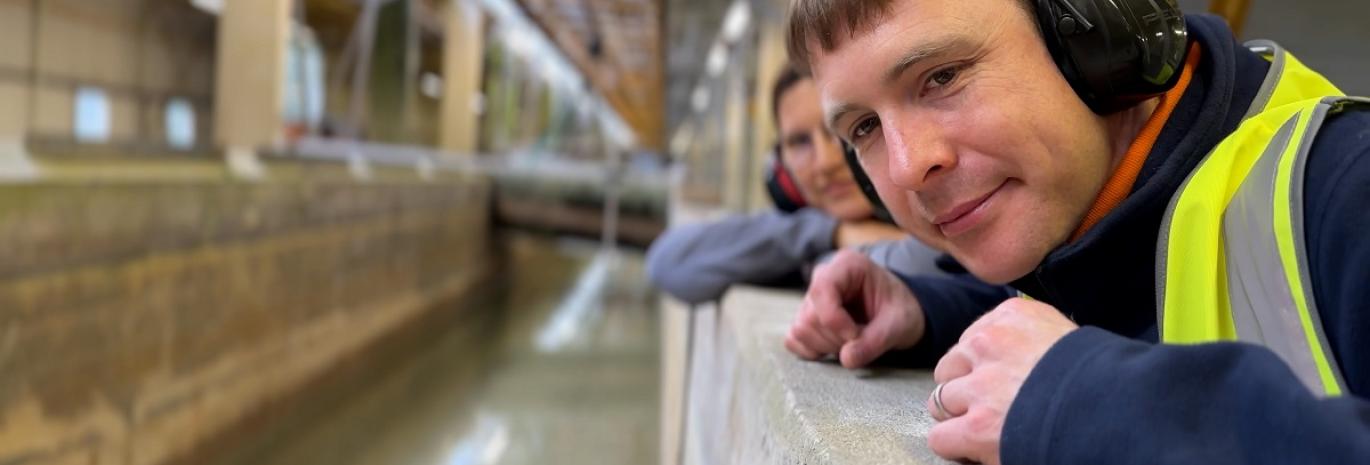 Two engineers looking on physical model of a tsunami 