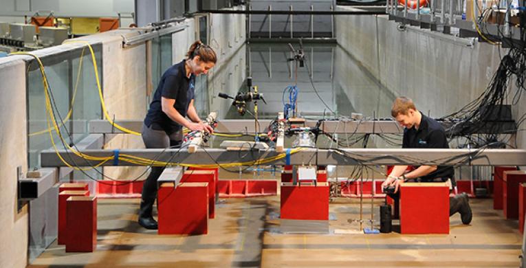 Photo of two people working on the tsunami simulator