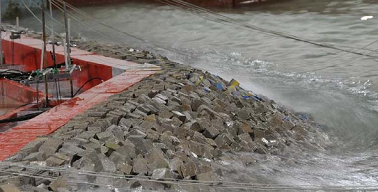 Close-up of wave on breakwaters in physical model